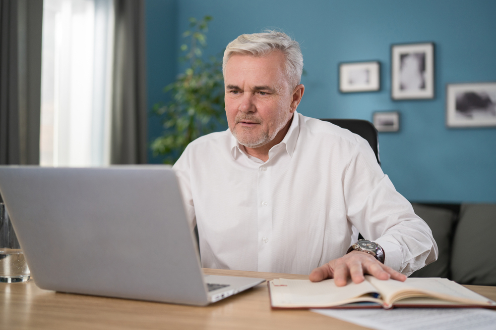 Qualified,Serious,Male,Businessman,Doing,Online,Research,,Reading,News,,Making