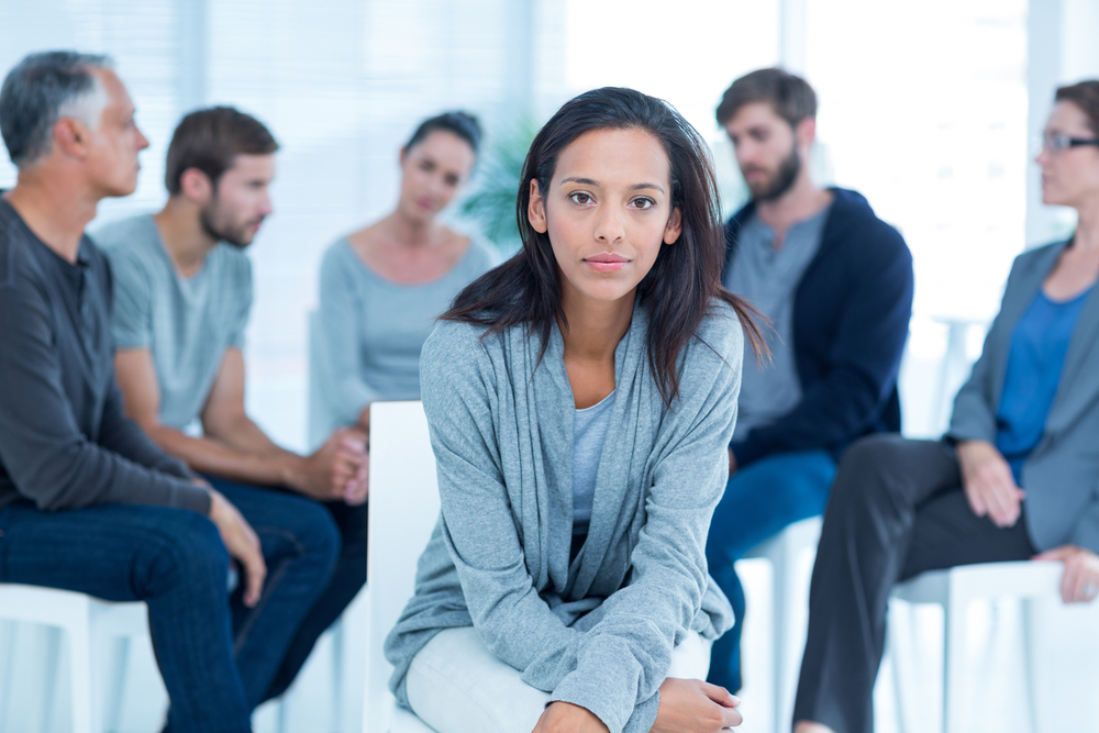 Woman,Comforting,Another,In,Rehab,Group,At,A,Therapy,Session